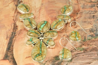 Outstanding Necklace and Earrings Set. Mother Nature is Truly Amazing! Genuine Boulder Turquoise set in Sterling Silver. The cabachons are of Boulder Turquoise, you can see the veins of Turquoise running through the host rock. The Boulder Turquoise Mine is located in northeast Nevada. It was discovered in 1970 by a Shoshone sheep herder. Production is small due to the remote location and winter weather. Boulder Turquoise is valued for both it's beauty and rarity. Every stone is unique. Created by Navajo Artist Lucy Valencia. Signed L. J. by the artist.